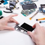 Repairman disassembling phone for inspecting