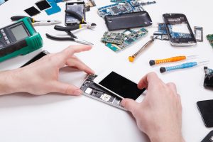 Repairman disassembling phone for inspecting